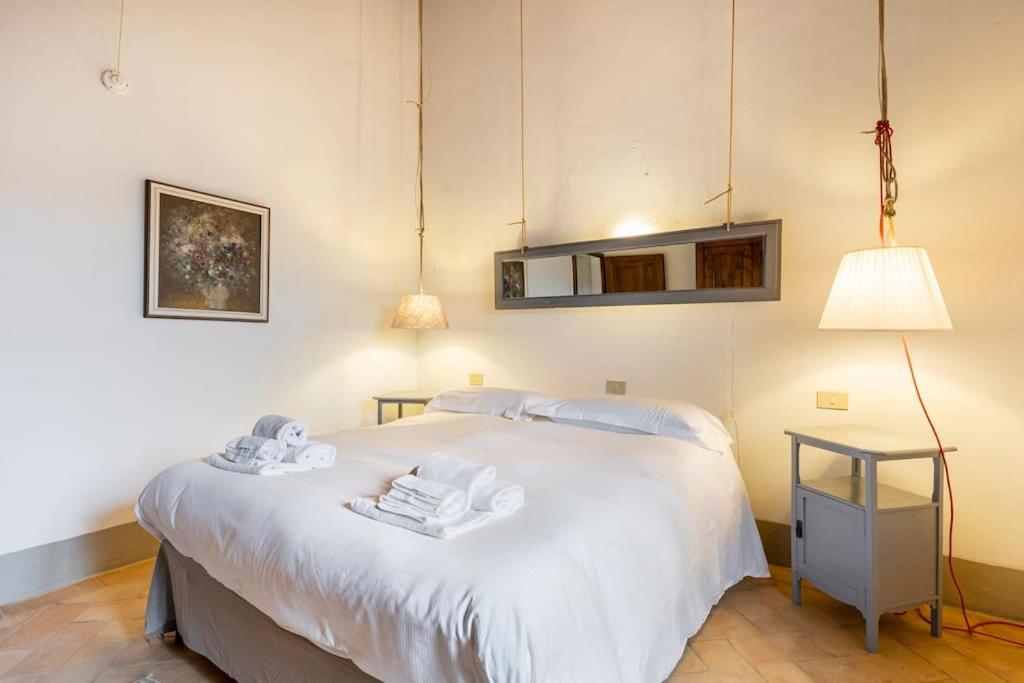 Postel nebo postele na pokoji v ubytování La Casa di Vignoni Alto