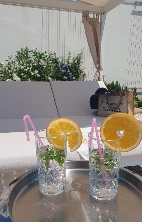 two glasses of water and orange slices on a table at Villa Hvar II in Ivan Dolac