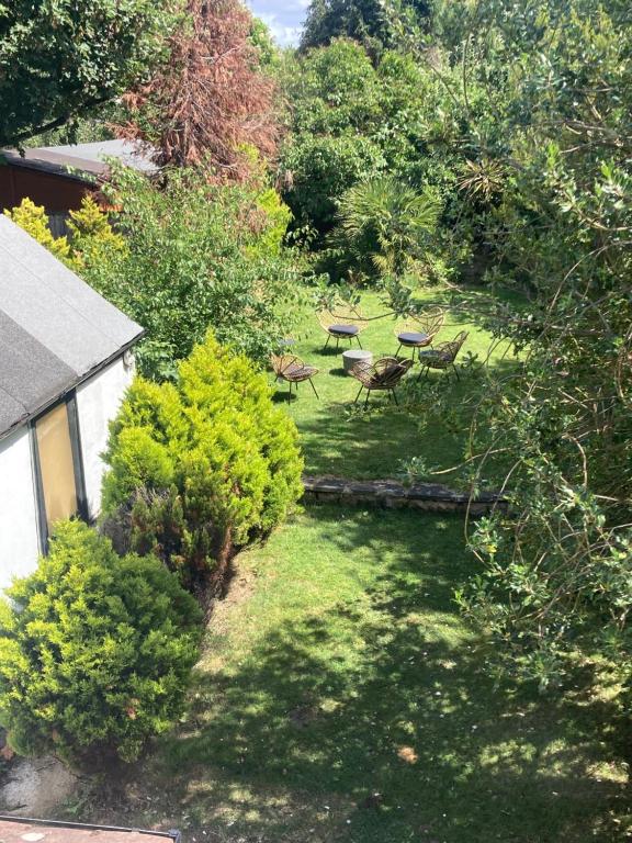 an overhead view of a garden with chairs and trees at Highfield Home with free parkings, Surbiton, Kingston upon Thames, Surrey, Greater London , UK in Surbiton