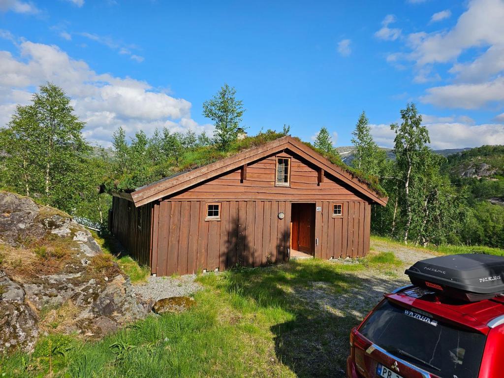 a barn with a car parked in front of it at Nice Sirdal Bungalow in Ådneram 