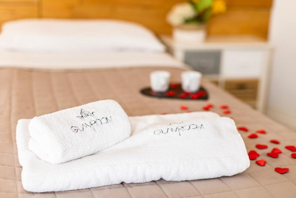 two white towels sitting on top of a table at Glamroom Vatican Apartment in Rome