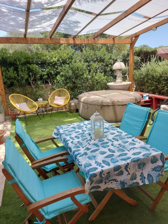 a table and chairs under a pergola at Elorina Sicily Home in Siracusa