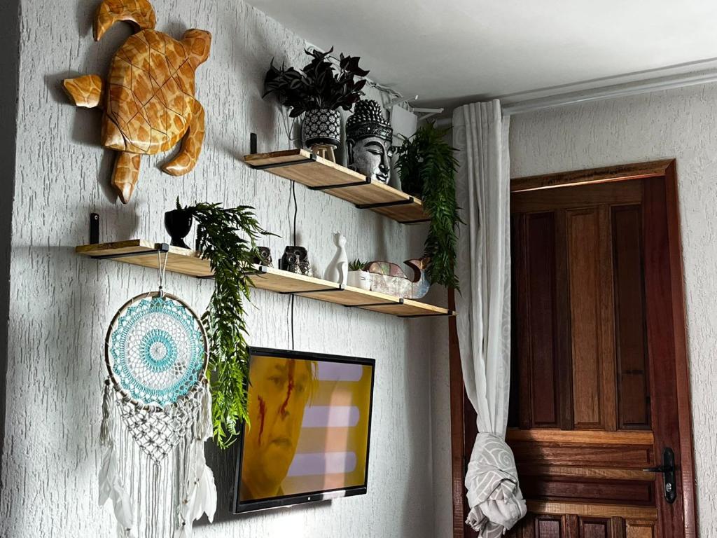 a room with shelves on the wall with plants at Meu Loft Barra Nova 4 in Saquarema