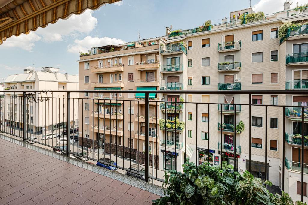 a large building with balconies on the side of it at Cosy Studio with balcony & private garage in Milan
