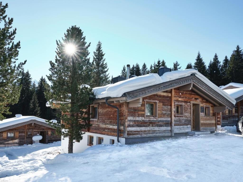 a log cabin with snow on the roof at Astn Hütten - Königsleiten - Ferienwohnungen in Königsleiten