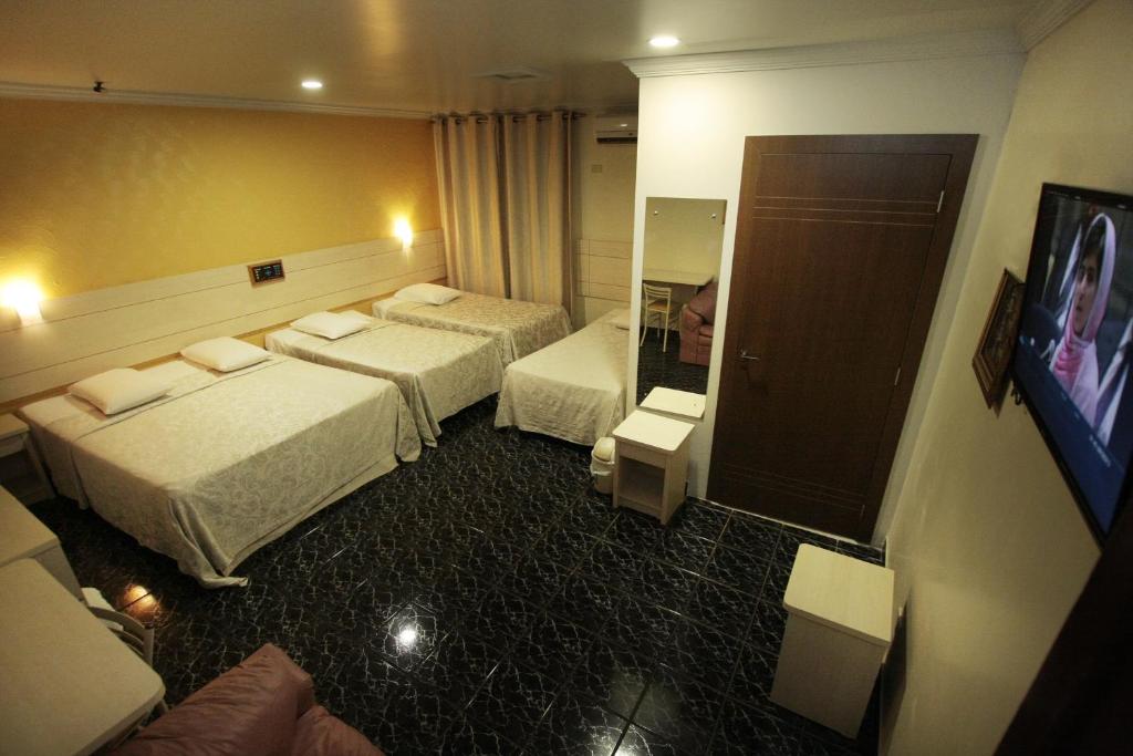 Postel nebo postele na pokoji v ubytování Hotel Três Fronteiras