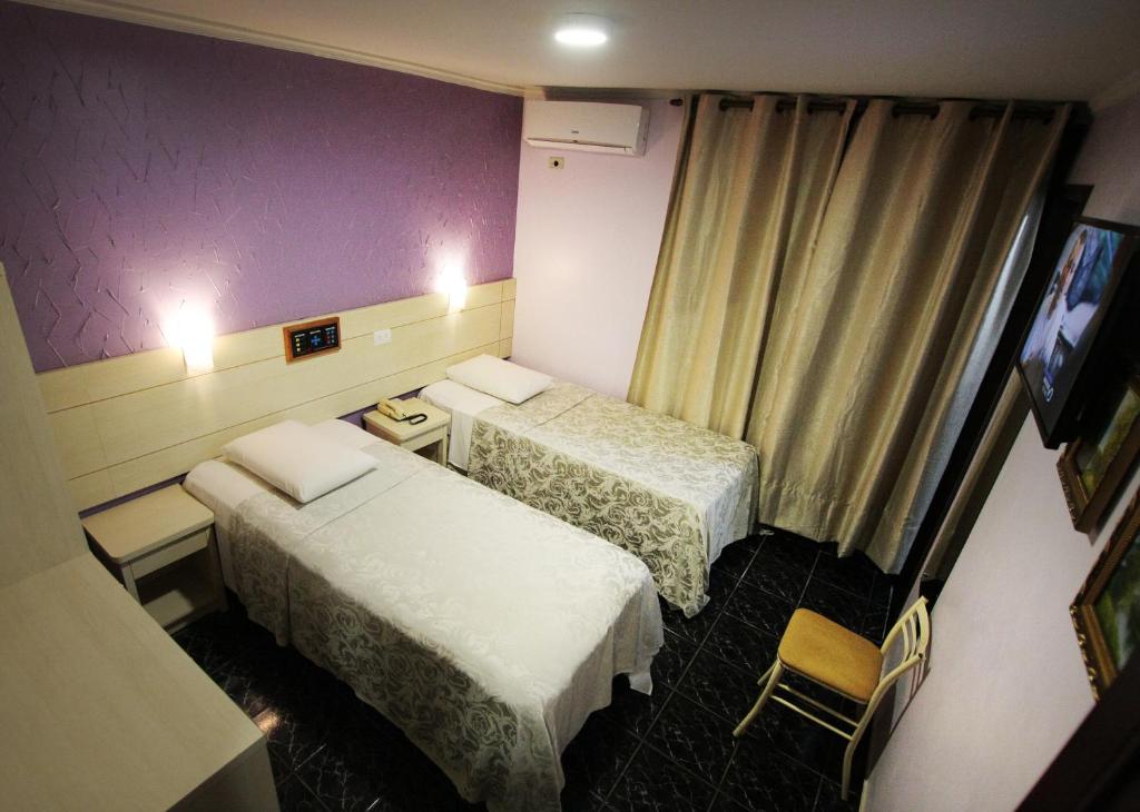 Postel nebo postele na pokoji v ubytování Hotel Três Fronteiras