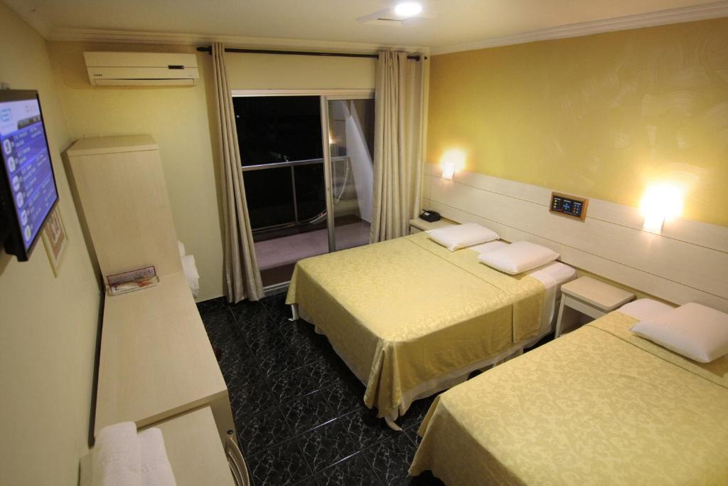 Postel nebo postele na pokoji v ubytování Hotel Três Fronteiras