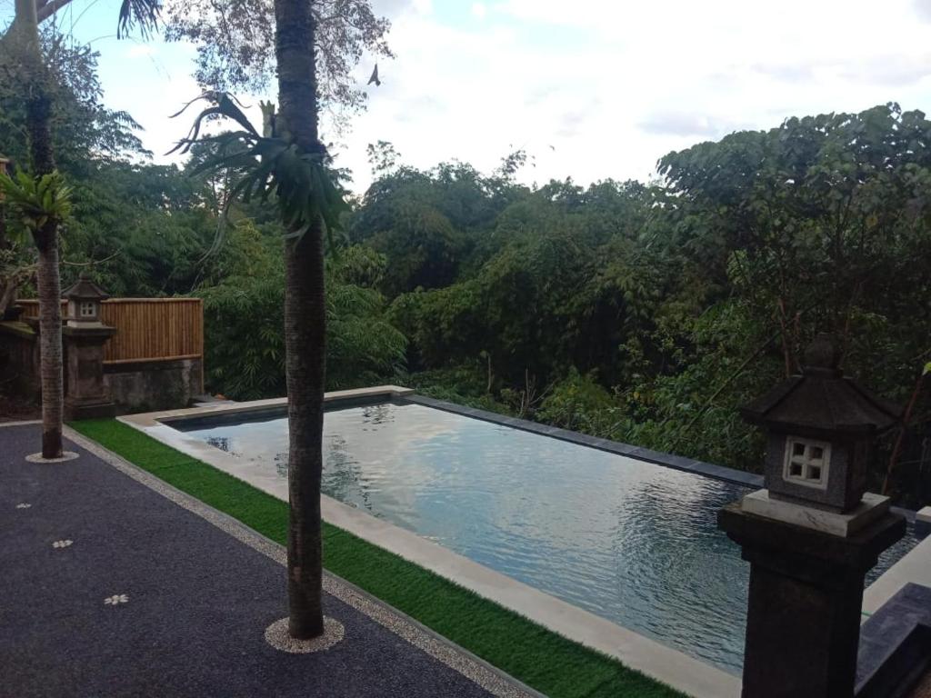 Bazén v ubytování Ketut Kasta Guest House nebo v jeho okolí