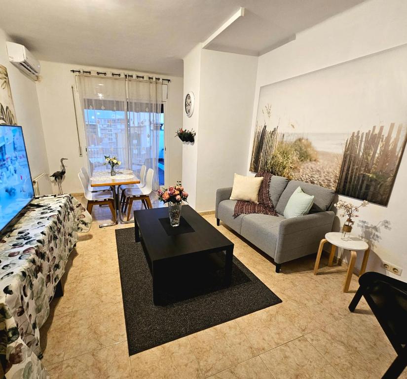 a living room with a couch and a table at Hotel Wellamar in Sant Feliu de Guíxols