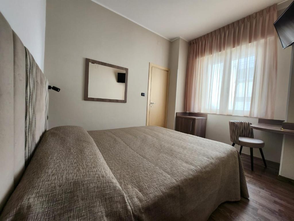 Postel nebo postele na pokoji v ubytování Hotel Miramare Dipendenza
