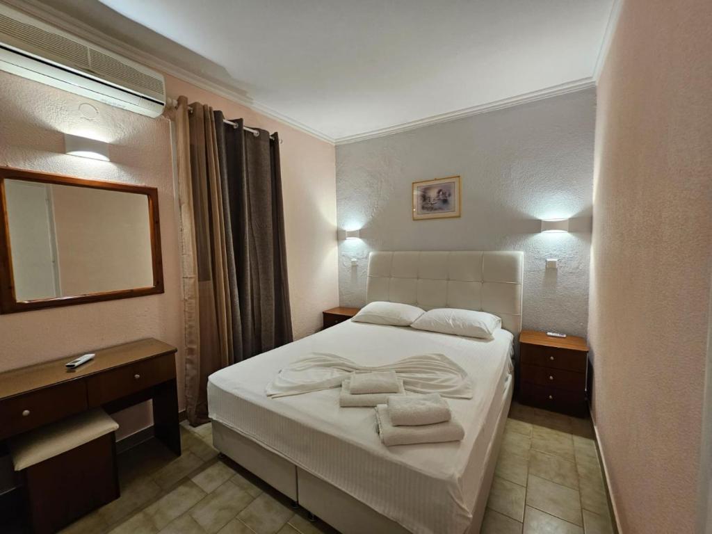 A bed or beds in a room at Corfu Glyfada Beach Apartment 40