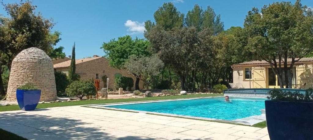 una piscina nel cortile di una casa di La Pitchounette Mas Val-Chênaie Gordes a Gordes