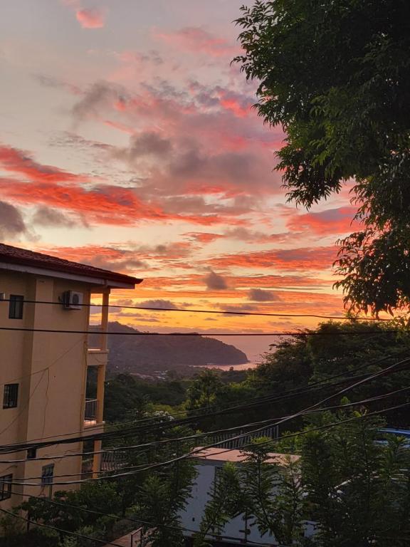 a view of a building with a sunset in the background at Villa Roberto Vista Hermosa in Sardinal