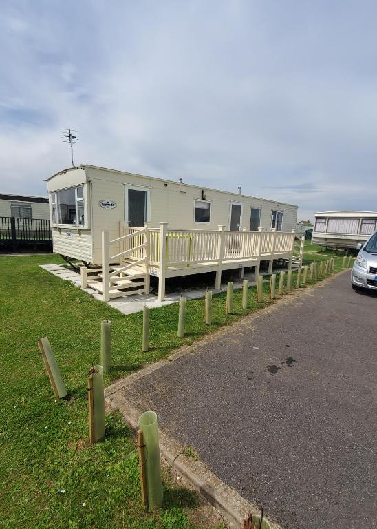 a mobile home is parked on the side of the road at 3 BEDROOM CARAVAN AT THE GRANGE HOLIDAY PARK, CHAPEL ROAD INGOLDMELLS in Addlethorpe
