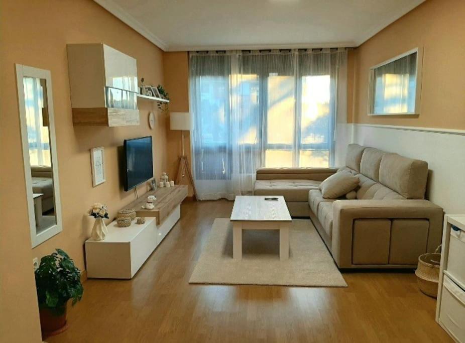 a living room with a couch and a table at Apartamento El Horrín ( Colunga ) in Colunga