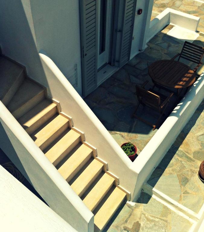 a staircase leading to a house with a chair at Gaia Serifos Apartments in Rámos