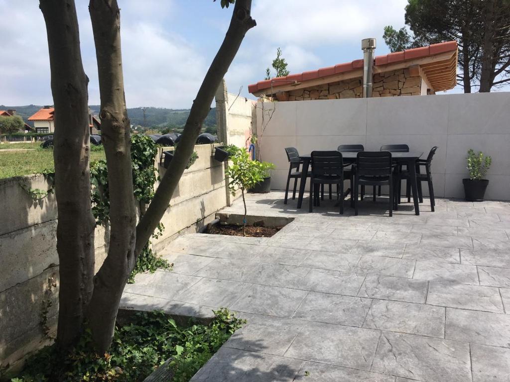 a patio with black chairs and a table at LA MARINA in Galizano