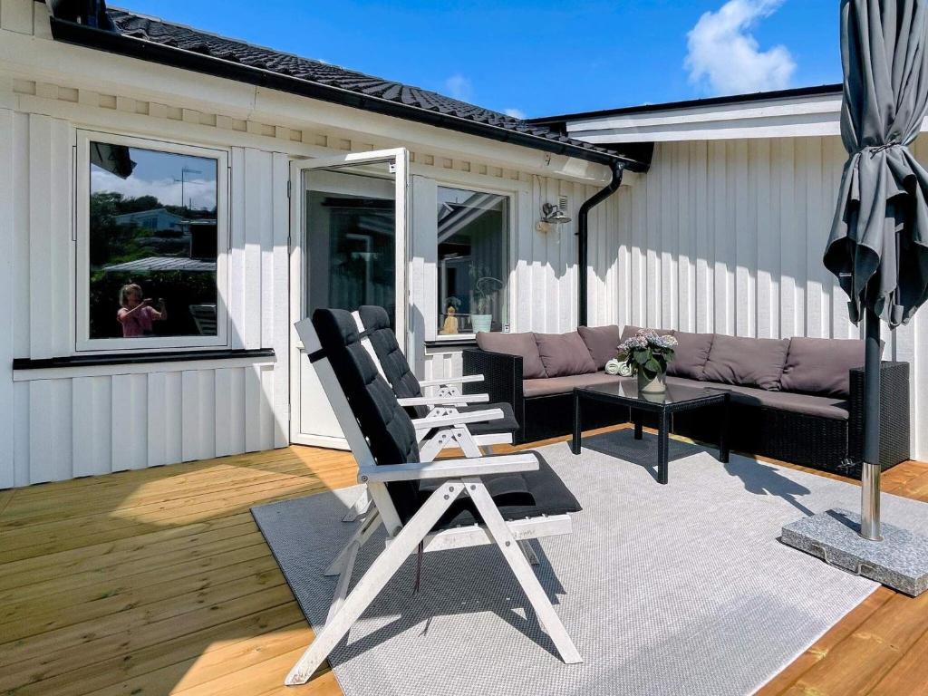 a patio with a chair and a couch and a table at Holiday home TORSLANDA IV in Torslanda