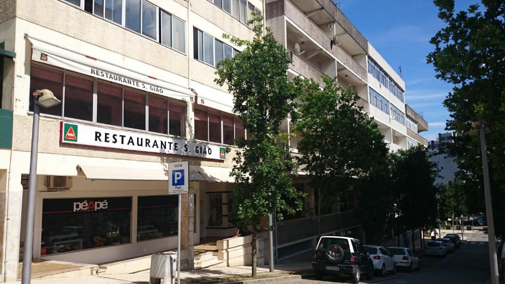 a building with a sign for a restaurant and spa at Residencial S. Gião in Valença