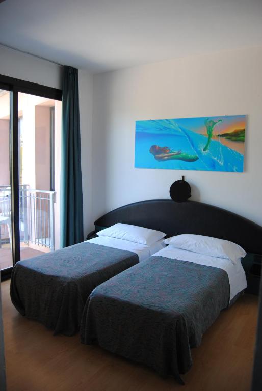 Postel nebo postele na pokoji v ubytování Hotel Capriccio