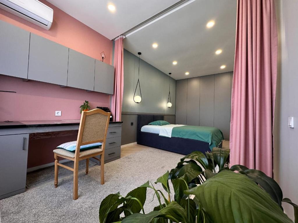 1 dormitorio con 1 cama, 1 silla y 1 planta en Атлант, нижняя Мега, комната для девушек Only for girls, en Almaty