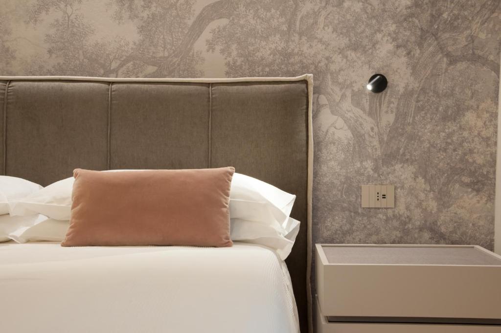 レーヴィコ・テルメにあるAmbiente 90のベッドルーム1室(枕付きのベッド1台、壁付)