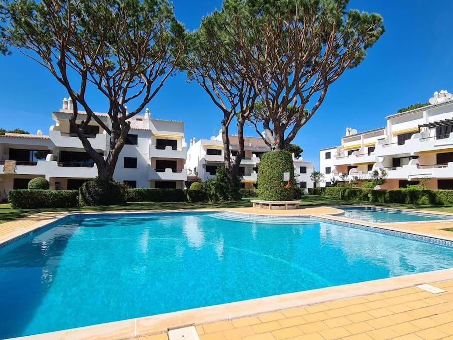 a large swimming pool in front of a building at Solar Dos Pinheiros in Quarteira