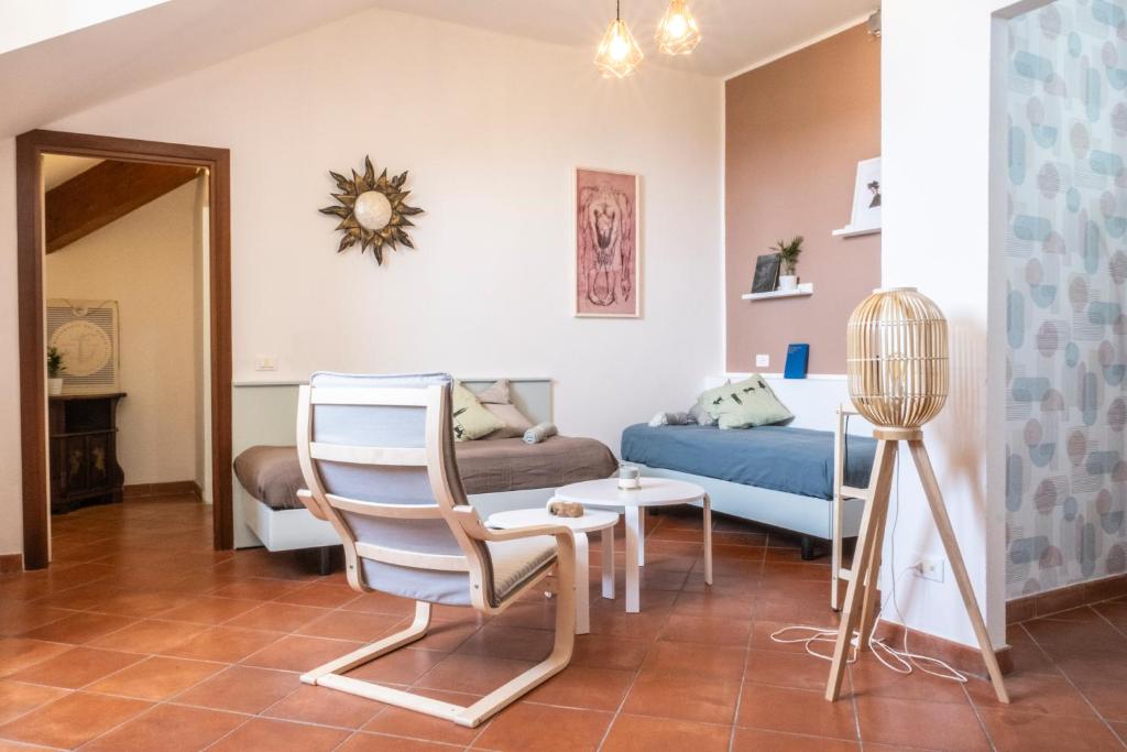 a living room with a bed and a table and a chair at Palazzo Oddo in Albenga