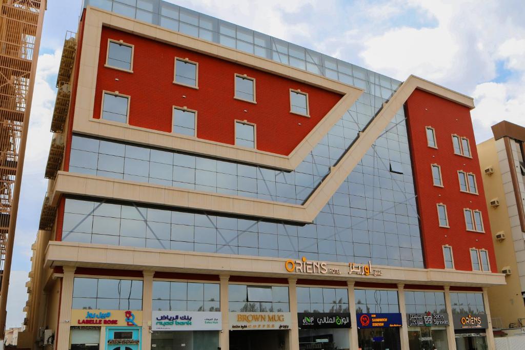 a building with a red brick at Oriens Hotel in Taif