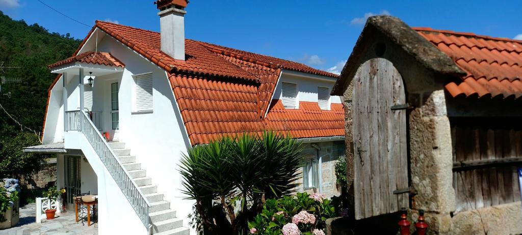 uma casa branca com um telhado vermelho em Eido Benito em Mondariz