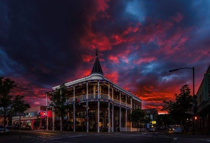 a building on a street with a cloudy sky at Weatherford Hotel in Flagstaff