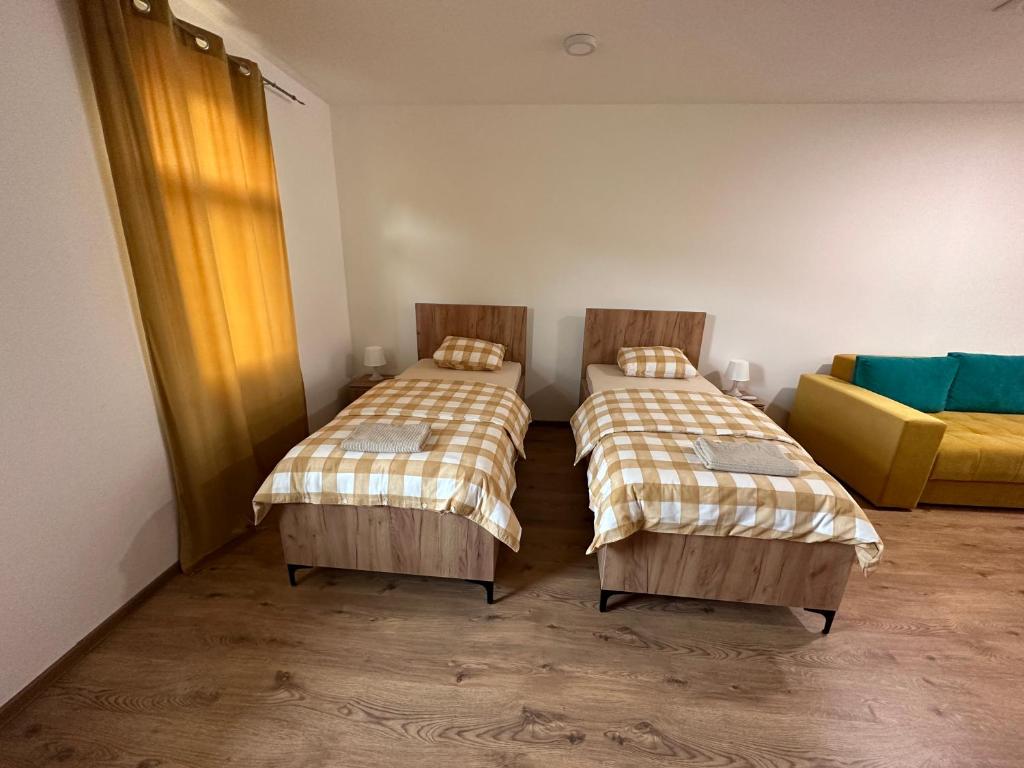 Postel nebo postele na pokoji v ubytování Apartmani BMD