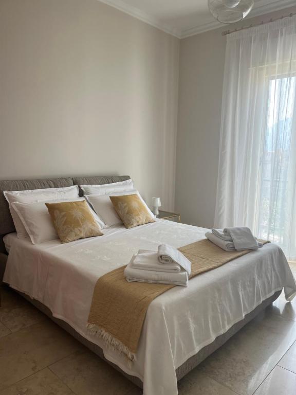 a bedroom with a large white bed with towels on it at Le Cupole di Palermo in Palermo