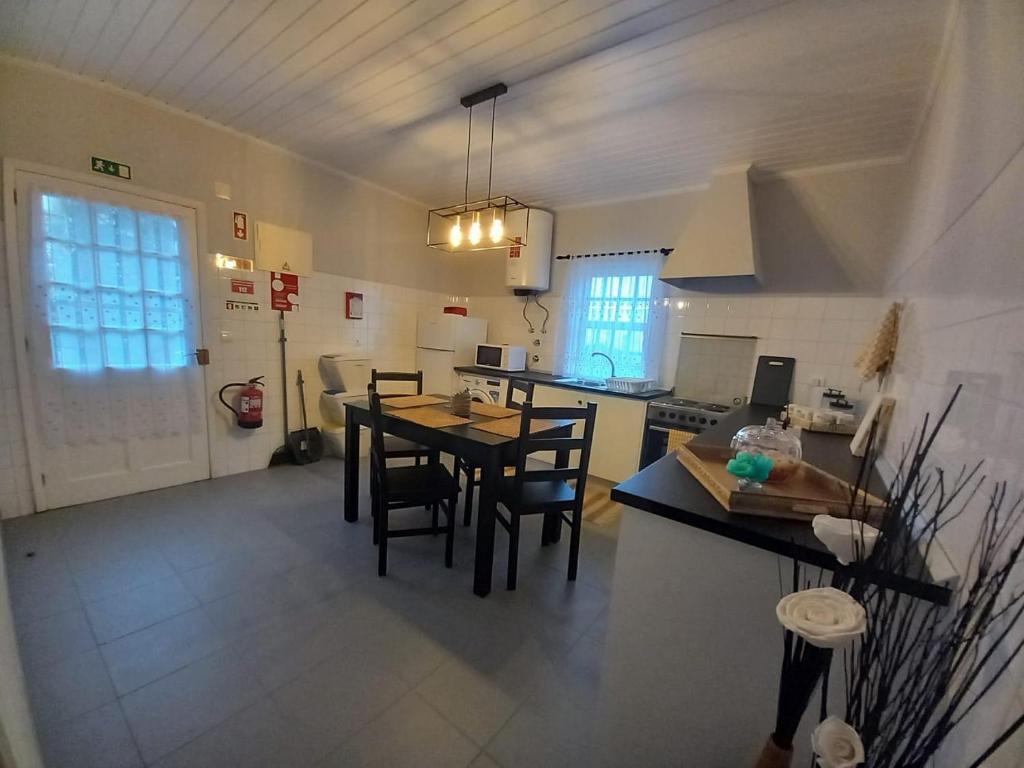 a kitchen with a table and chairs in a room at Mirateca House in Madalena