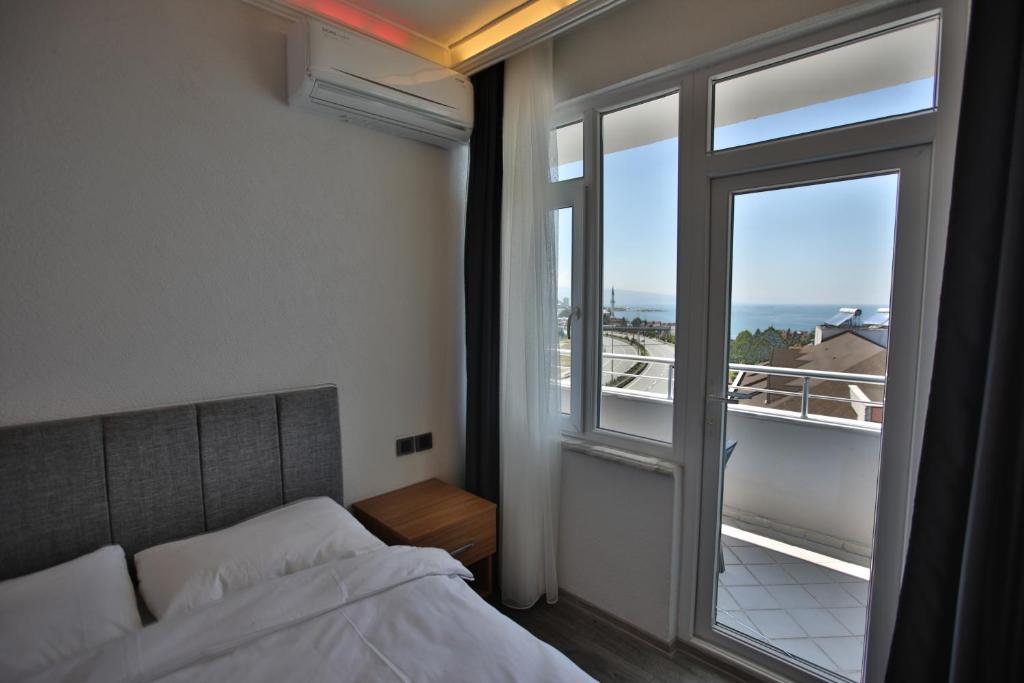 a bedroom with a bed and a large window at Black Pearly Hotel in Trabzon