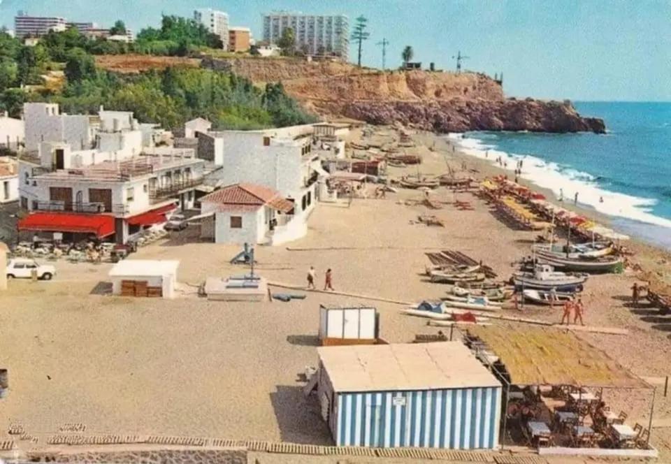 a beach with a bunch of buildings and the ocean at CarihuelaCity in Torremolinos