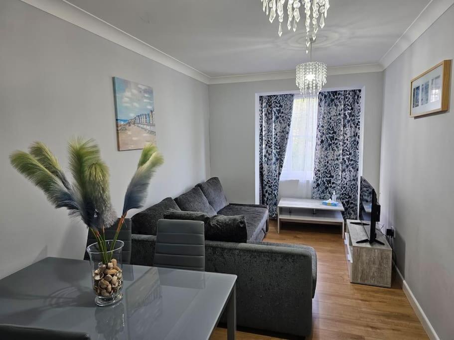 a living room with a couch and a table at Lovely Flat close to Shepherd's Bush in London