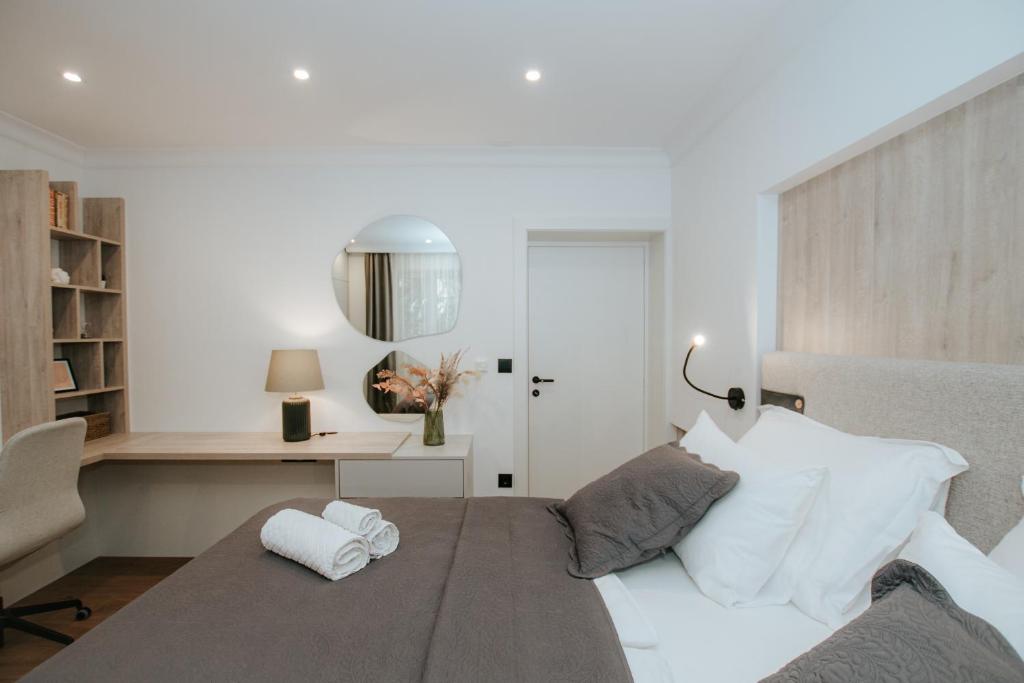 a bedroom with a large white bed with a desk at Apartment Datala in Marina