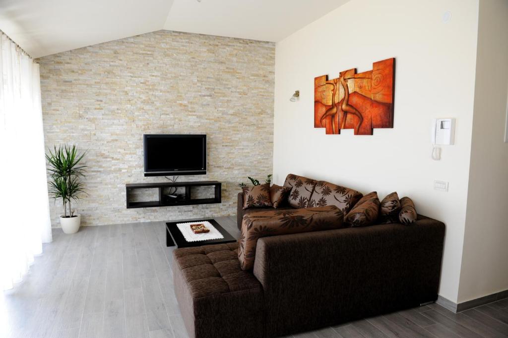 a living room with a couch and a tv at Apartment Lara in Vodice