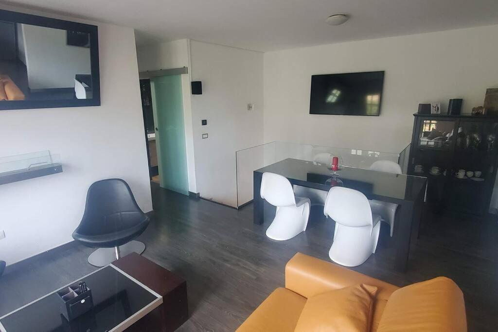 Una sala de estar con un sofá, una mesa y sillas. en Stylish apartment in Tegueste, en Tegueste