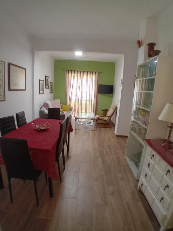sala de estar con mesa y sillas y comedor en Apto a 5 min a pie de la playa, en Málaga