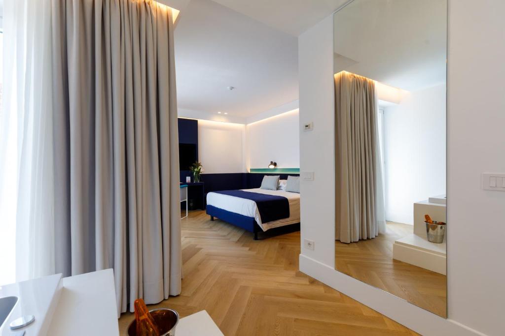 Postel nebo postele na pokoji v ubytování Grand Hotel Cesare Augusto