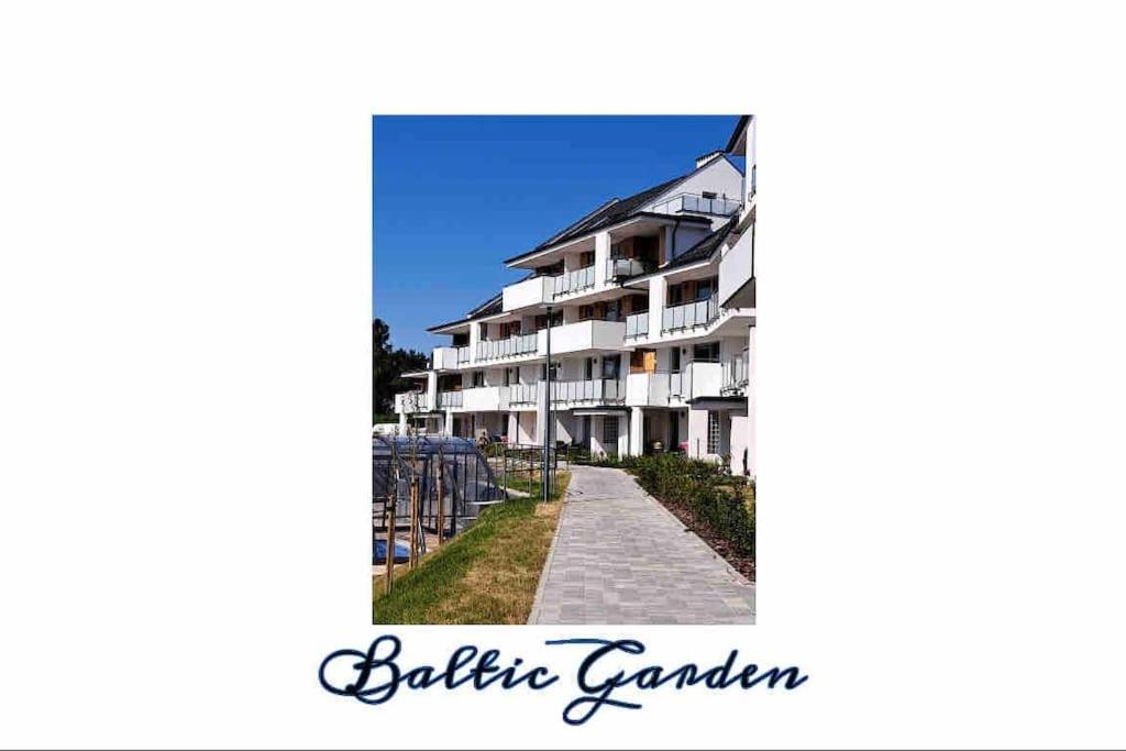 a picture of a apartment building with a pathway at Baltic Garden apartament dwupoziomowy 56 m² in Sztutowo