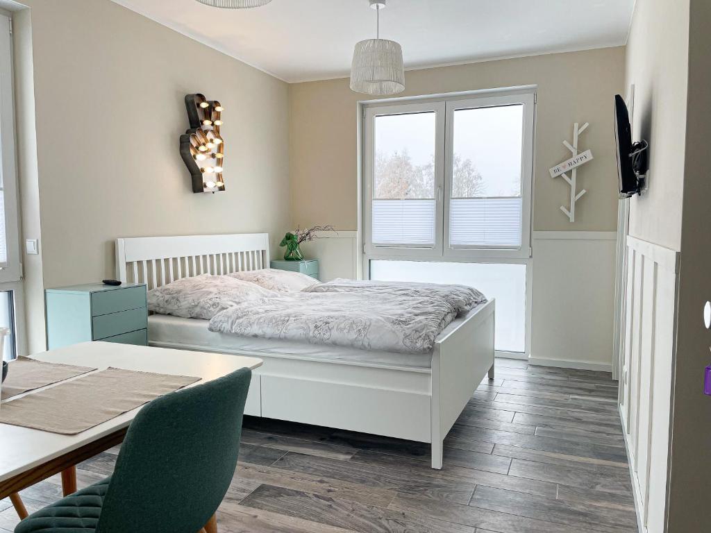 a bedroom with a bed and a table and a dining room at Appartement - Wildecker Ferienbutze in Hönebach