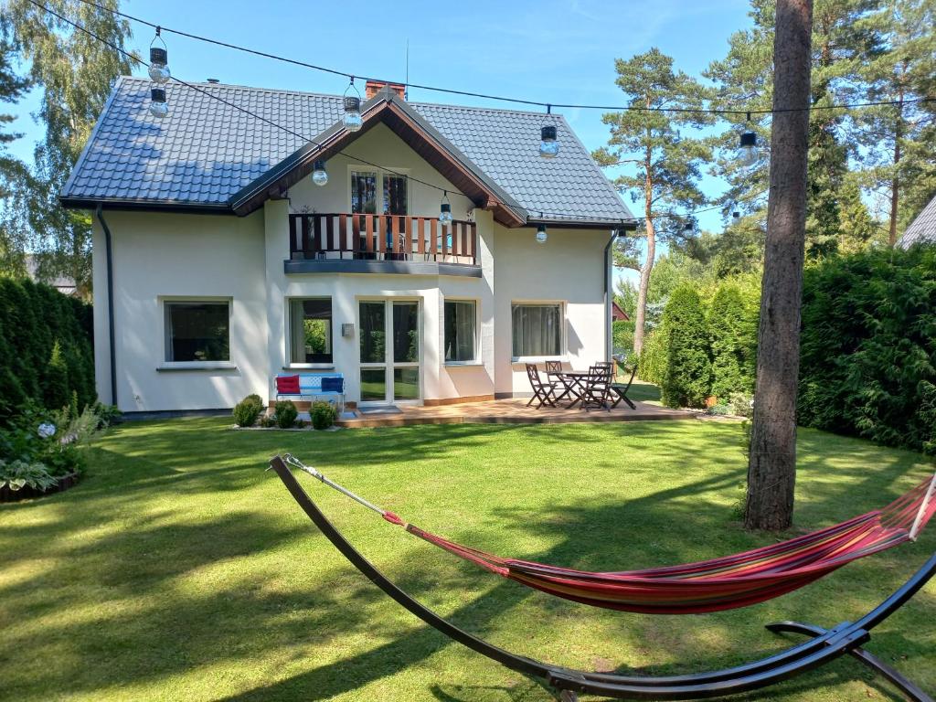 a hammock in front of a house at Barwy Morza in Kopalino