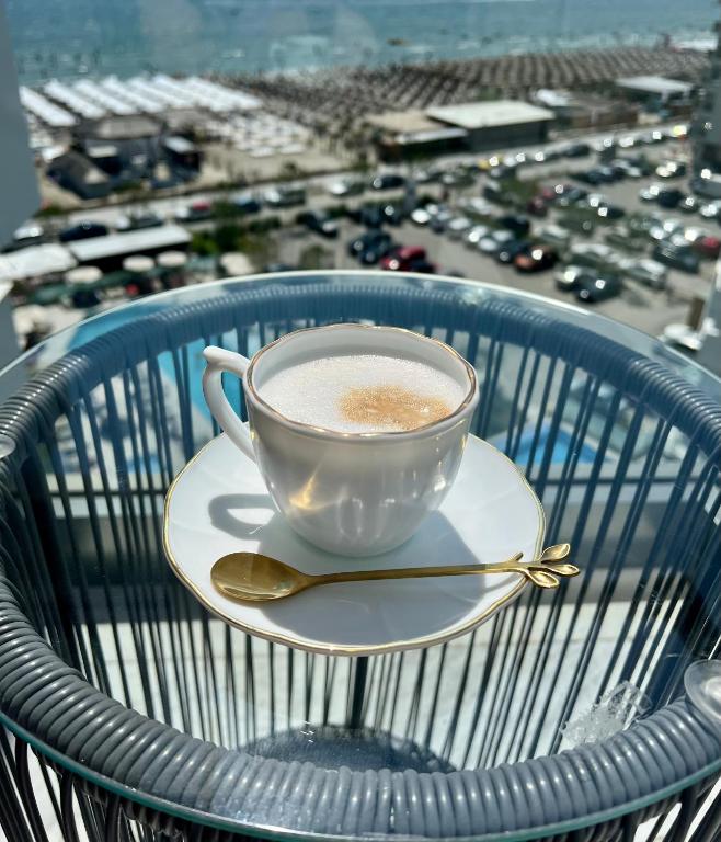 a cup of coffee sitting on top of a chair at Elite Summer Suite in Năvodari