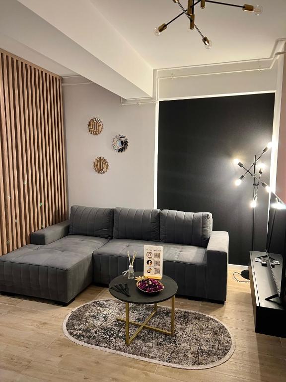 a living room with a couch and a table at Elite Summer Suite in Năvodari