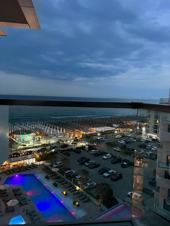 a view of a parking lot and the ocean at night at Elite Summer Suite in Năvodari