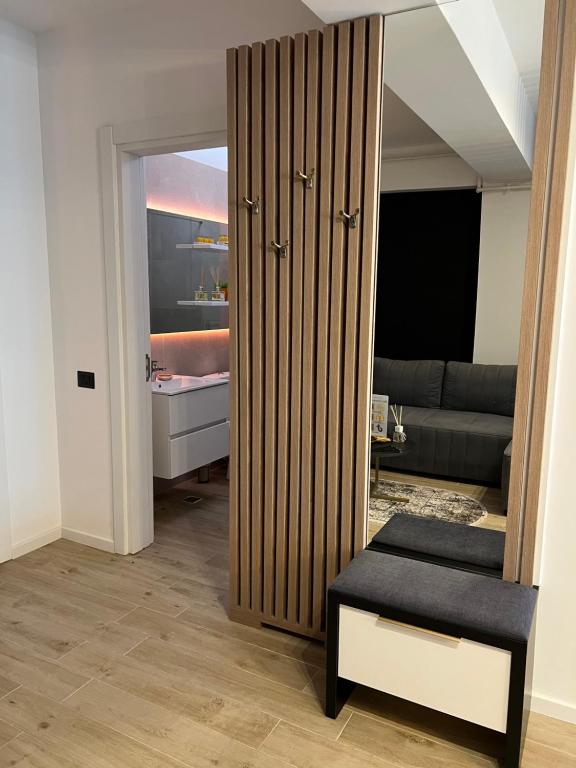 a living room with a large wooden closet at Elite Summer Suite in Năvodari